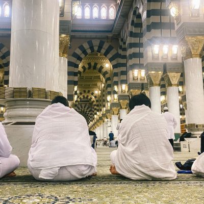 Pilgrims seated in prayer inside the Prophet's Mosque in Madinah